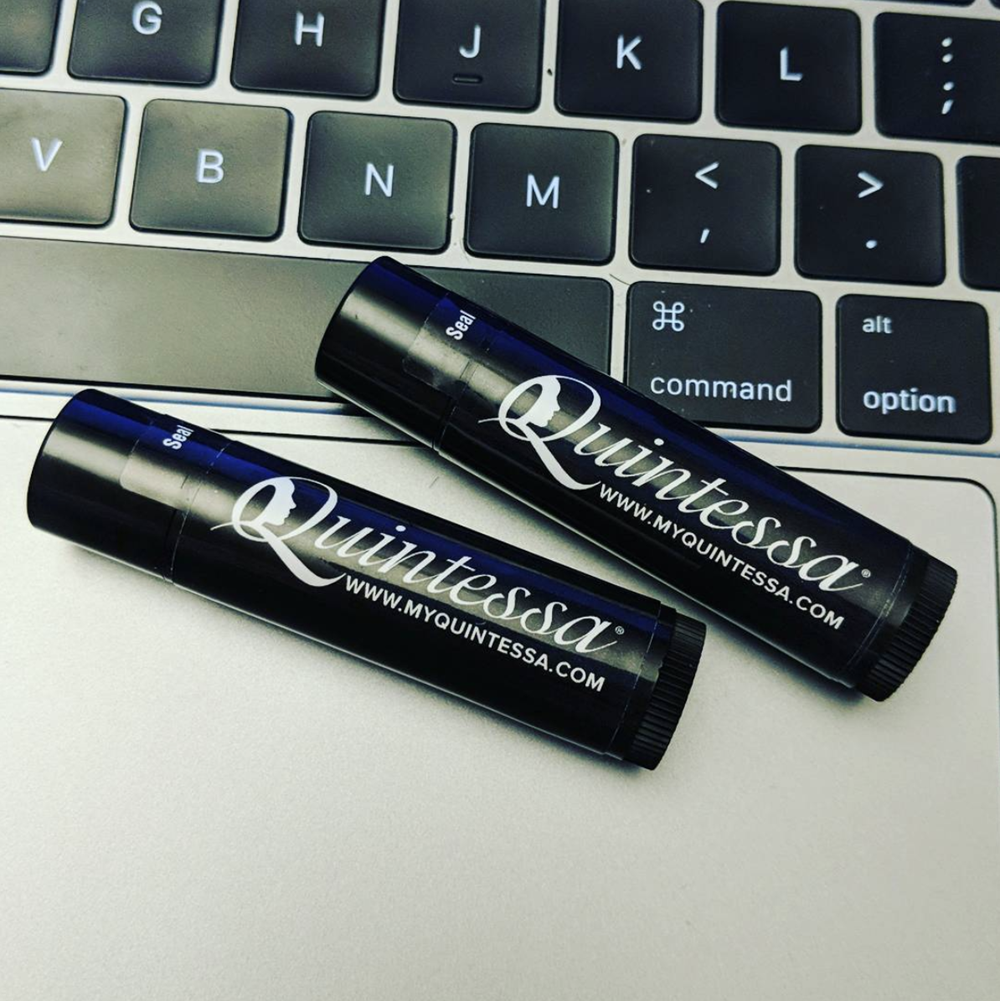 Customer photo from Nicholas of our Black Tube Lip Balm Tub - 100-Pieces, two black tubes on a laptop keyboard